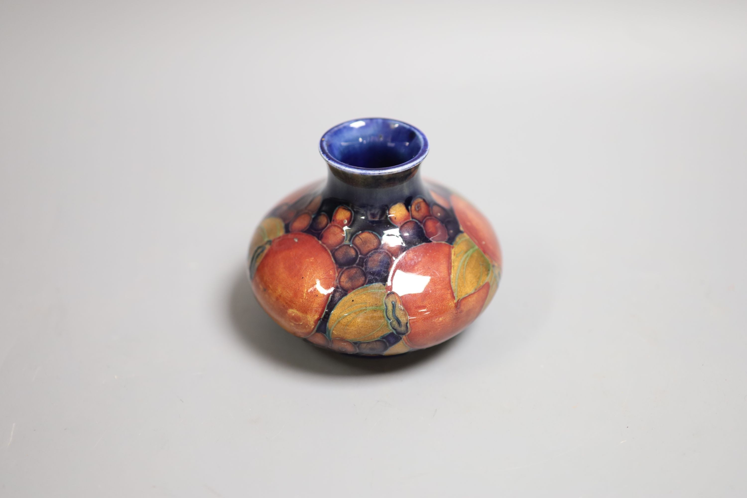 A Moorcroft Pomegranate squat baluster vase, 9cm high